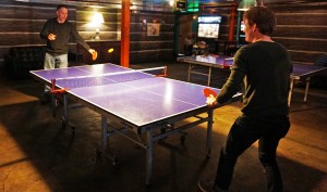 Punch Bowl customers play ping-pong.