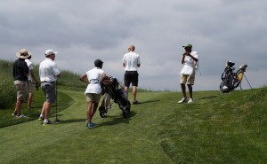 Caddies haul bags up a hill at CommonGround.