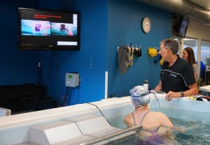 Mann reviews swimming footage with a student. 