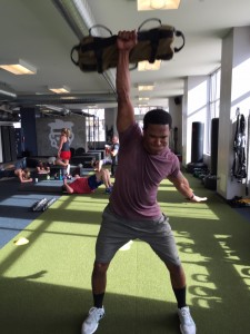 A gym goer hoists a Brute Force bag overhead. Photo courtesy of Brute Force.