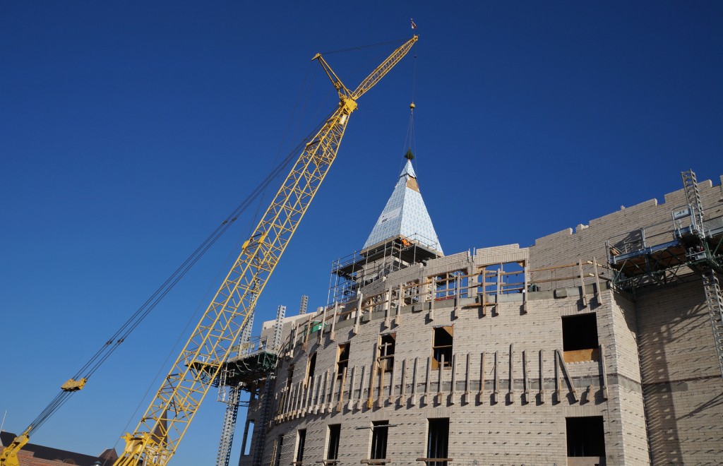 Crews lower a new spire into place atop a DU building. Photos by Amy DiPierro.