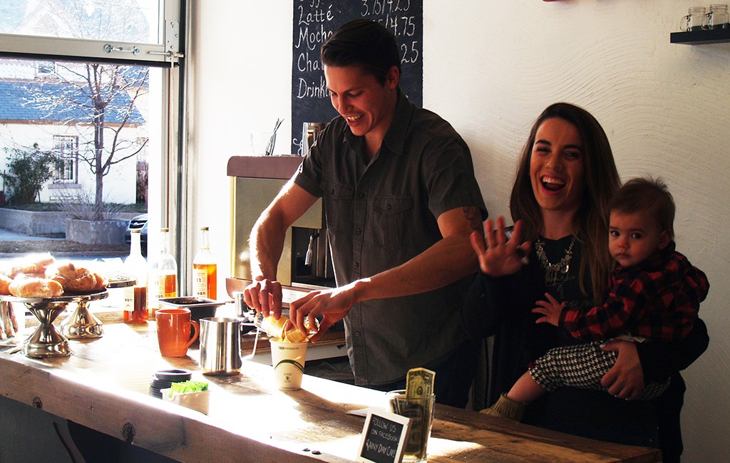 From left: Wayne and Lauren Harvey with their child Echo at the newly opened Rainy Day Coffee. (Bailey Connor)