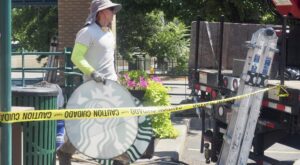 Construction worker removing Starbucks signage