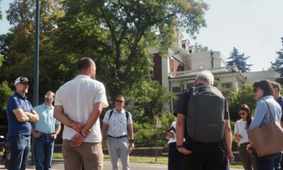 Professionals gathering in a circle across the street from the Colorado Governor's Mansion