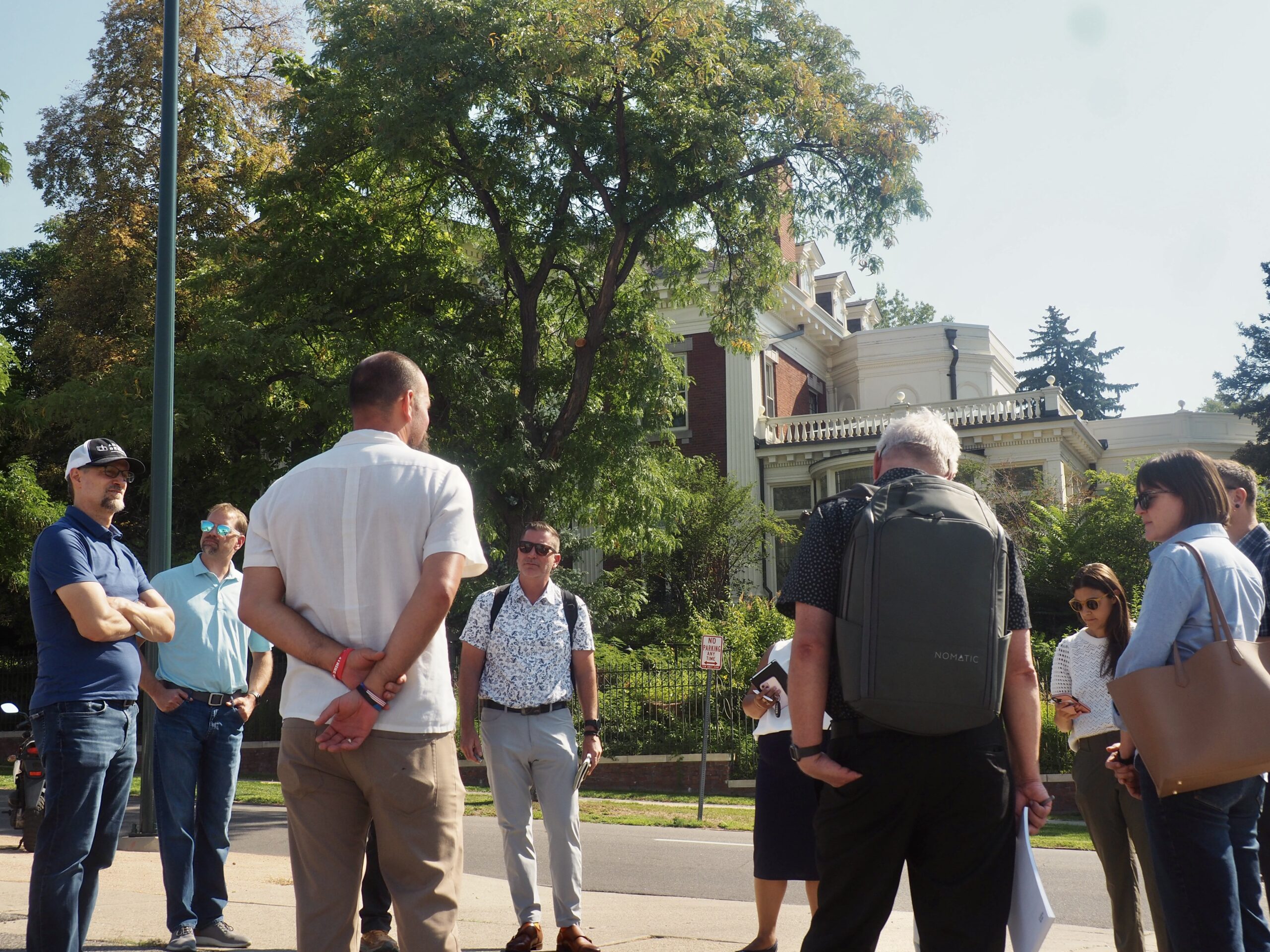 State seeks developer to build on parking lot by Governor’s Mansion 1 Professionals gathering in a circle across the street from the Colorado Governor's Mansion