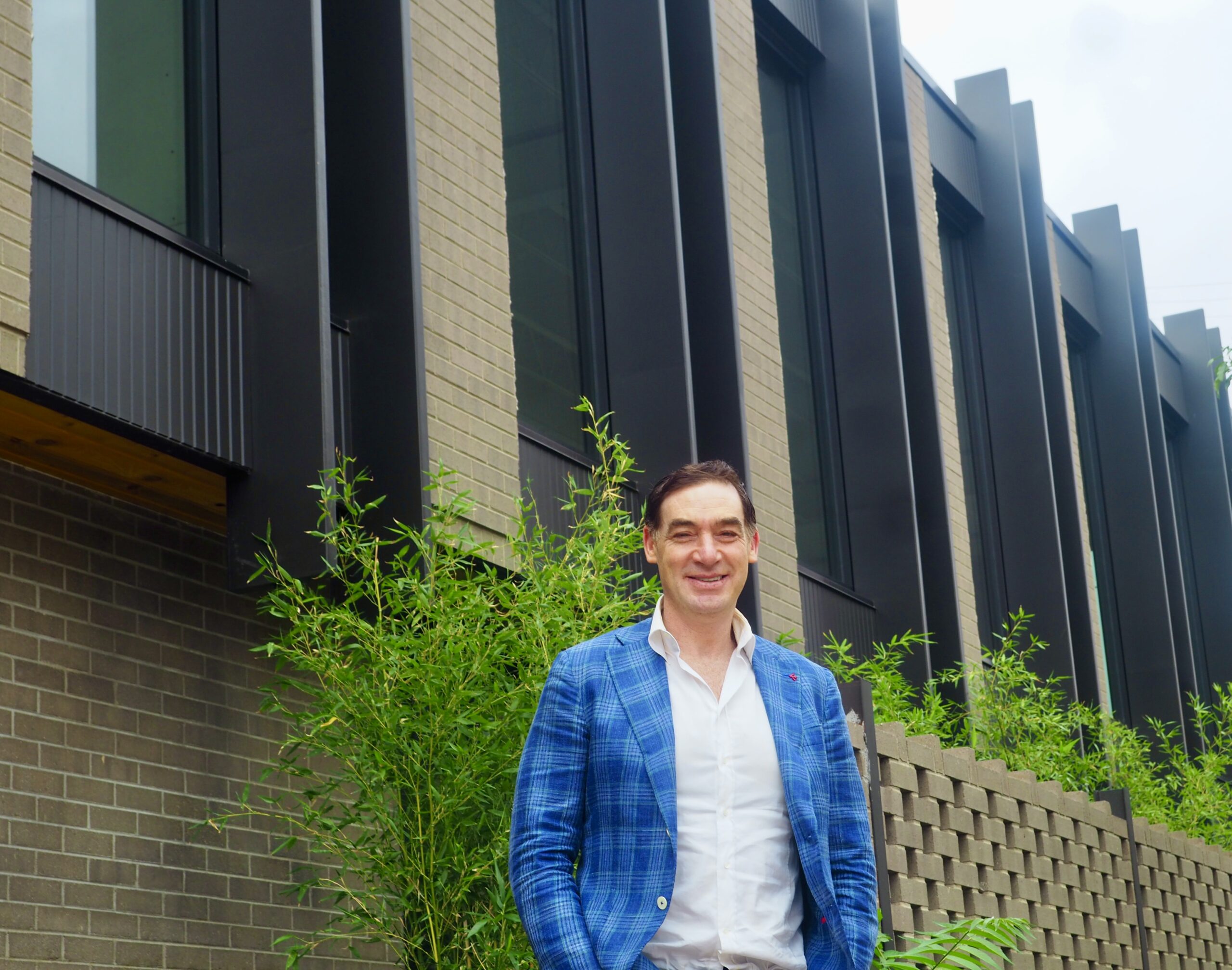 Justin Borus stands in front of 101 S. Madison St.