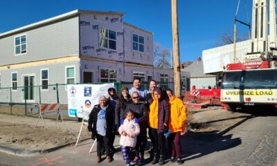 GES Coalition leaders in front of a modular home construction site.