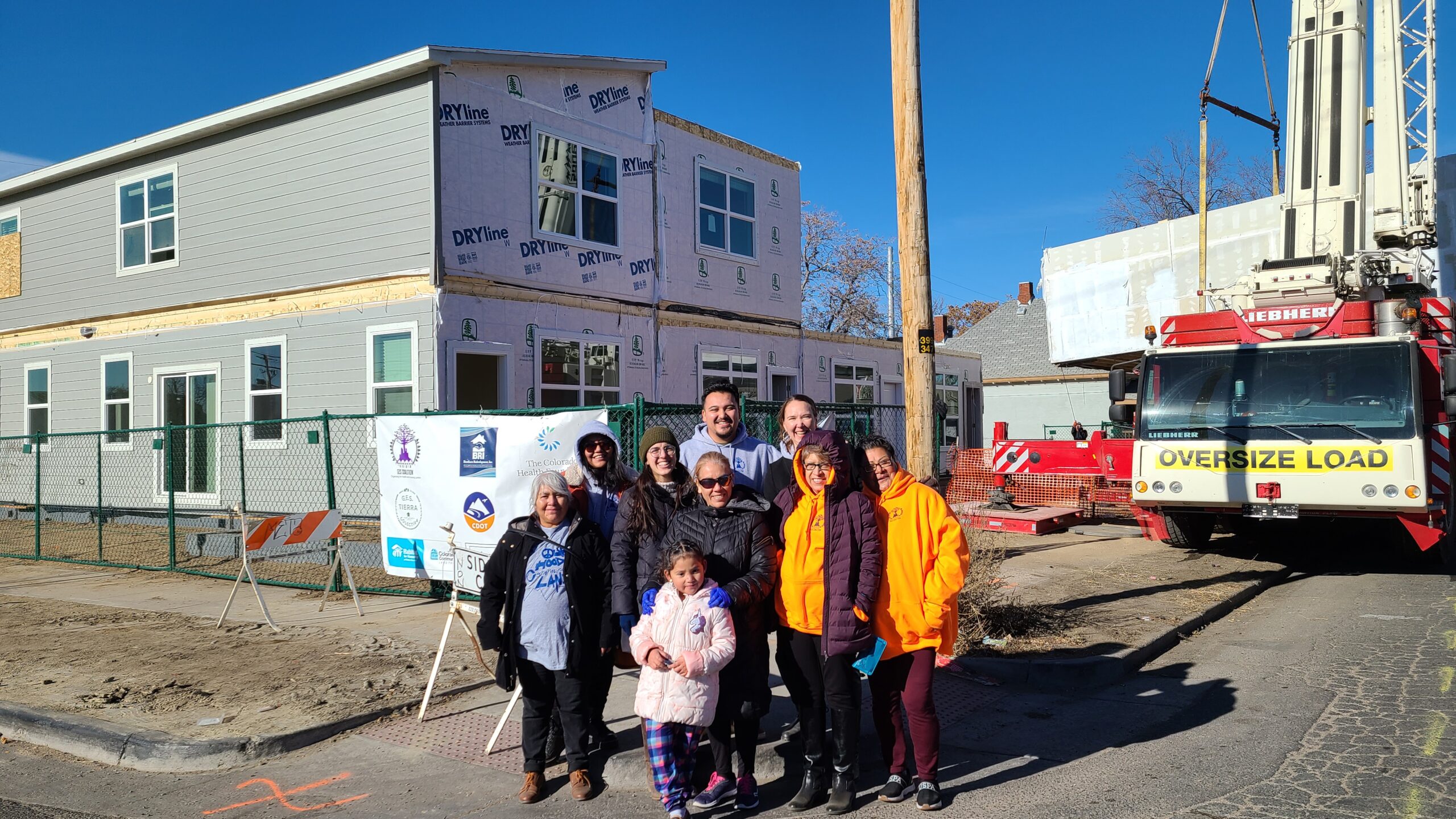 GES Coalition leaders in front of a modular home construction site. 