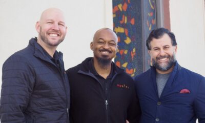 Brian Stamer, left, stands with Joe Sanders and Anthony Albanese outside the nonprofit's new home. (Matt Geiger/BusinessDen)